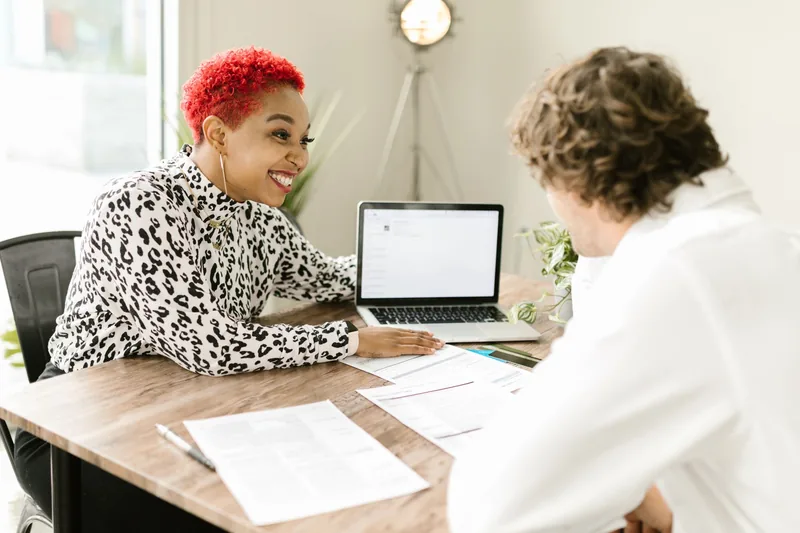 Accountant going over tax paperwork with a small-business client