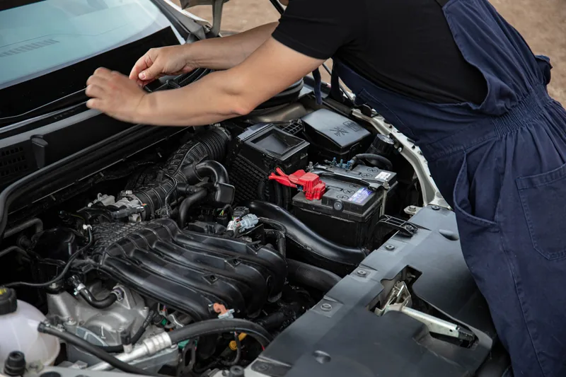 Mechanic doing engine maintenance under the hood