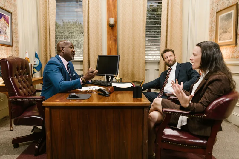 Lawyers and a client in a consultation meeting