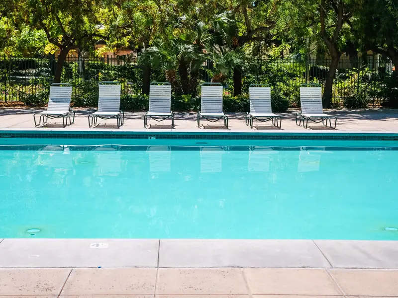 Clean pool with sun loungers on a sunny day