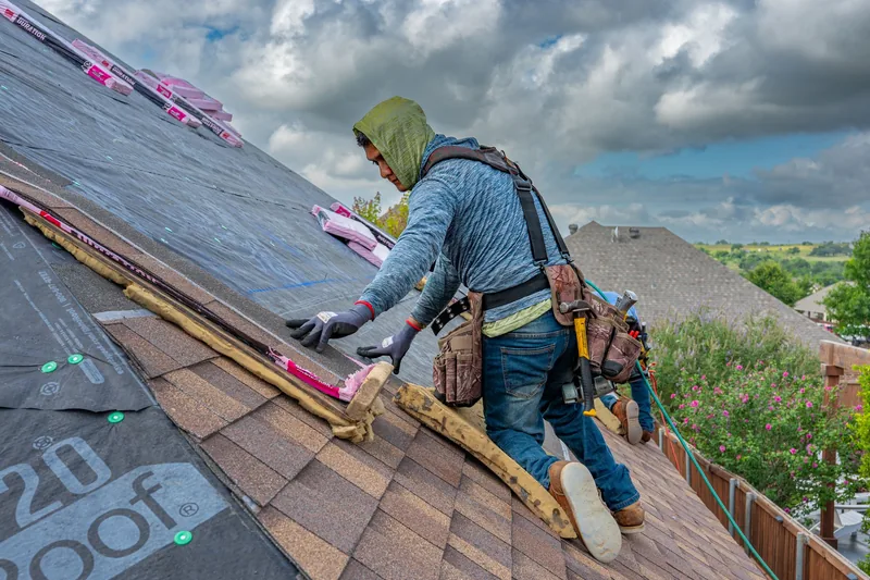 Roofer laying roof tiles on a sunny day